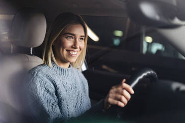 Portrait of happy young woman driving a car - DIGF09020