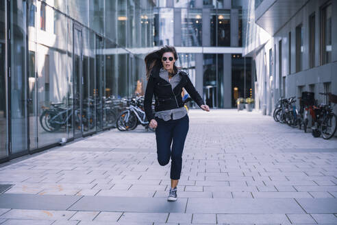 Woman with sunglasses running away - DHEF00002