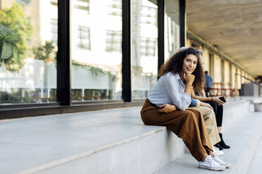 Women sitting on steps in the city - SODF00429