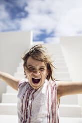 Girl with windswept hair, screaming out loud - MCF00501