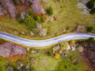 Italy, Trentino, Trento, Aerial view of empty highway in European alps during autumn - GIOF07892