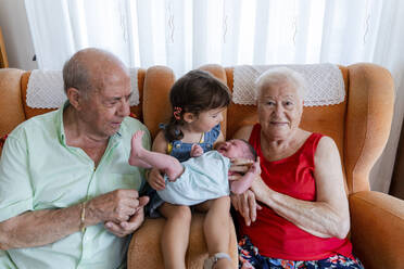 Großeltern mit kleinem Mädchen und neugeborenem Baby zu Hause - GEMF03312