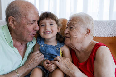 Happy grandparents with little girl at home - GEMF03314