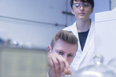 Female and male laboratory technician working together in a laboratory - SGF02454