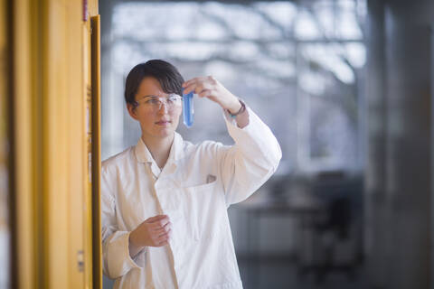 Female chemist at work examining a liquid stock photo