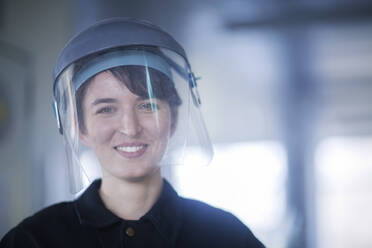 Portrait of female technician wearing safety helmet - SGF02466