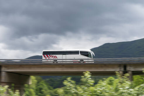 Spain, Elgoibar, Bus on elevated road in landscape - MTBF00248