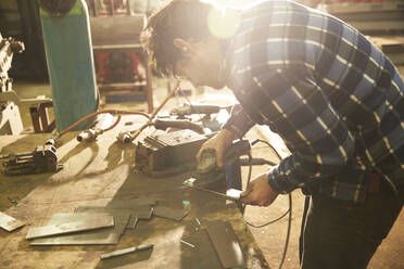 Metal worker working in workshop - PMF00924