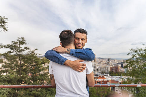 Portrait of happy man hugging his boyfriend, Barcelona, Spain - AFVF04337