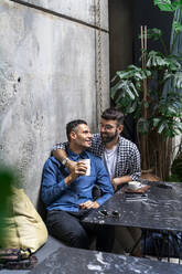Gay couple sitting at outdoor cafe, Barcelona, Spain - AFVF04350