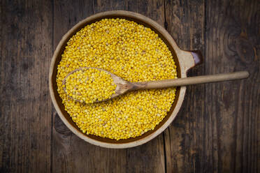 Overhead view of yellow organic lentils in bowl - LVF08447