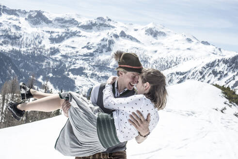 Happy couple kissing in the snowy mountains, Salzburg State, Austria - HHF05588