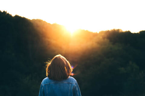 Portrait of a young woman in the sunset in summer stock photo