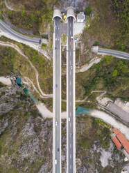 Aerial view of highway crossing river towards tunnel, Rijeka, Croatia. - AAEF05959
