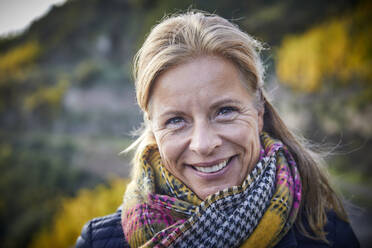 Portrait of a smiling mature woman outdoors - FMKF06047