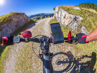 Senior man riding with his bicycle in the Vicentine Alps, Italy - LAF02445