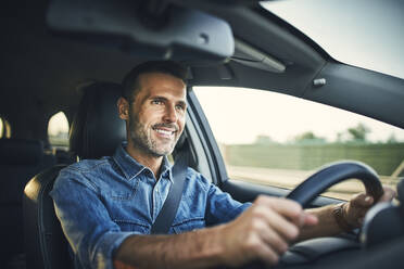 Handsome man driving a car - BSZF01554