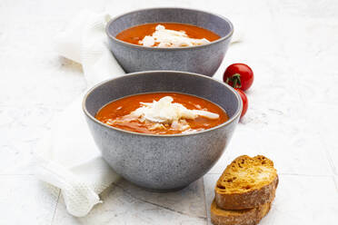 Two bowls of vegan tomato soup with coconut flakes - LVF08464