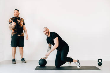Mann gibt Fitness-Trainer im Studio Daumen hoch - ISF23183
