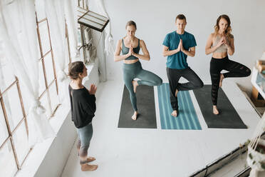 Yoga instructor teaching yoga in studio - ISF23202