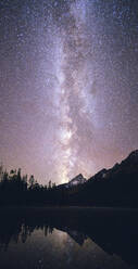 The Milky Way glows brightly above the Grand Teton Mountain Range. - CAVF69886