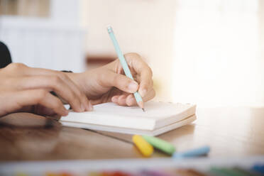 Close up female hands with pen writing on notebook. - CAVF69929