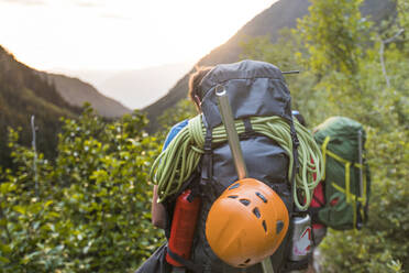 Rear view of male hiker wearing backpack - CAVF69987