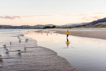 Little boy running at beach with reflection - CAVF69996