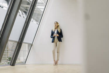 Young businesswoman in office having a break - JOSF03867