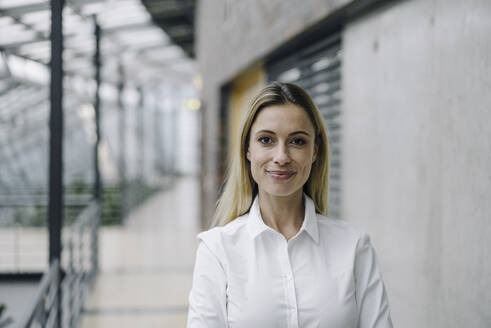 Portrait of a confident young businesswoman in a modern office building - JOSF03980