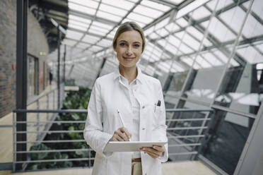 Portrait of a confident female doctor using a tablet - JOSF04026