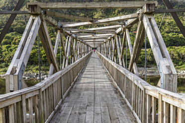 New Zealand, Diminishing perspective of wooden bridge at Brunner Mine site - FOF11401