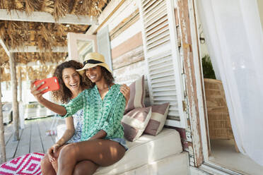 Glückliche junge Frauen Freunde nehmen Selfie mit Kamera-Handy am Strand Hütte Patio - HOXF04542