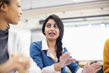 Businesswoman talking in meeting - HOXF04651