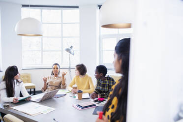 Businesswomen talking in conference room meeting - HOXF04707