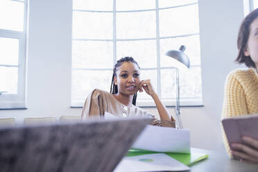 Attentive businesswoman listening in conference room meeting - HOXF04821