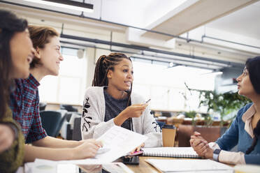 Businesswomen talking in meeting - HOXF04856