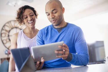 Couple using digital tablet - HOXF04860