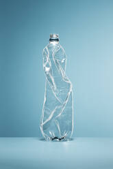 Crumpled, empty plastic water bottle - CAIF23419