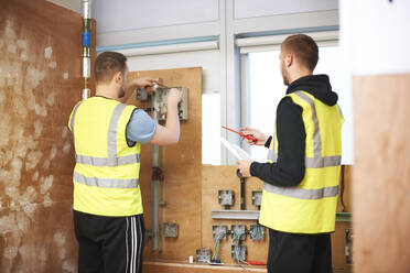 Male electrician students practicing in workshop - CAIF23474