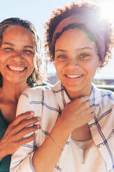 Portrait smiling, confident mother and daughter - CAIF23598