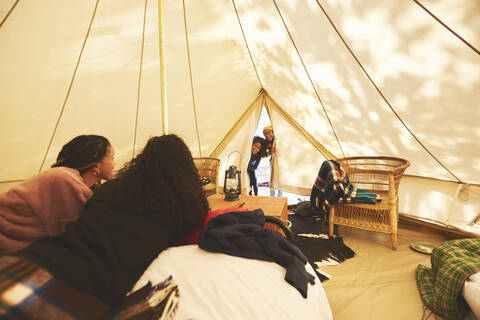 Curious kids peeking inside camping yurt stock photo