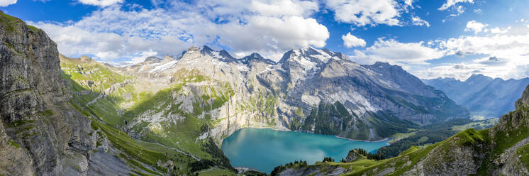 Aerial panoramic of Oeschinensee lake surrounded by woods in summer, Bernese Oberland, Kandersteg, Canton of Bern, Switzerland, Europe - RHPLF13060