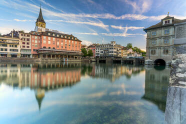 St. Peter church and old buildings of Lindenhof mirrored in Limmat River at dawn, Zurich, Switzerland, Europe - RHPLF13308