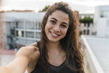 Young woman taking selfie on rooftop deck - CUF53782