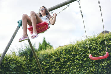 Girl on swing in garden - CUF53845