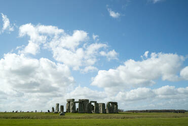 Mid distance view of Stonehenge on field against cloudy sky - CAVF70622
