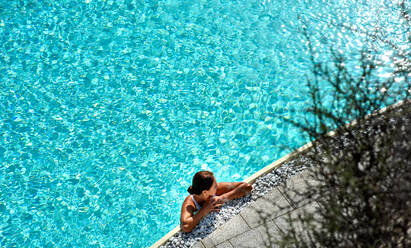 Woman relaxing in swimming pool - CUF53926