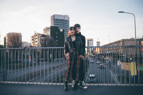 Trendiges Paar, das sich auf einer Brücke umarmt, Mailand, Italien - CUF54084