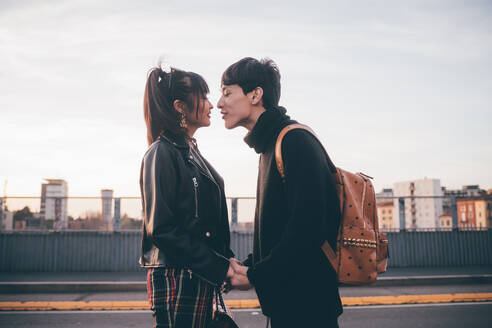 Affectionate young couple on street, Milan, Italy - CUF54094